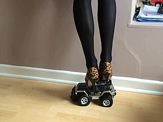 Woman's High Heels Crush Small Toy Car In The Garage Setting With Various Shoes And Toys.