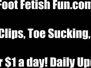 in a femdom session, she makes him worship her feet, sucking on toes while giving a footjob and licking them passionately