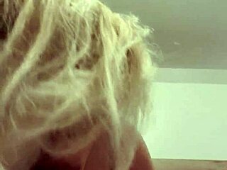 The wife is giving a great blowjob on webcam, her blonde hair bouncing as she sucks her husband's wet cock.