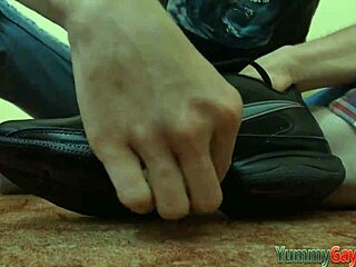 Gay dude engages in footjob fetish by sniffing shoe during solo masturbation