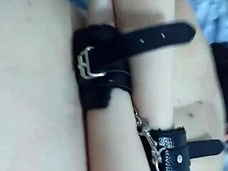 The black man with big cock fucks the handcuffed little whore in bdsm scene.