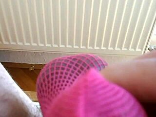 pink fishnet socks get cumshot on cock.