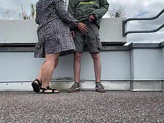 I'm spanking this sexy milf's gorgeous fat ass as she jerks my cock on the parking lot roof.