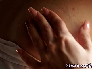 a gorgeous european babe with small tits fingers herself in an erotic, romantic setting