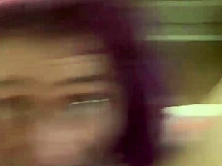 Purple haired girl gives a suggestive blowjob