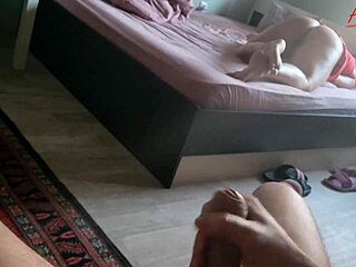 A busty stepmom on the bed during solo masturbation session