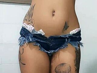 Tattooed brunette Bia in tight jeans shorts gets anal fisting and assfucking