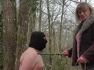 Whore submits in forest BDSM femdom scene