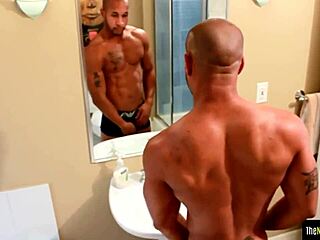 tattooed black jock strokes his swollen dong.