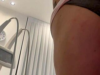 A blonde beauty strips and then wears a dress again in a rather seductive manner