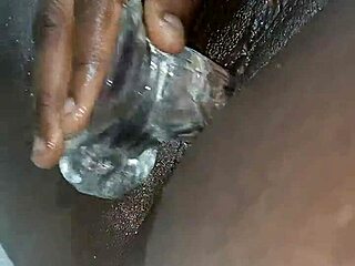 Ebony babe squints during intense solo play!