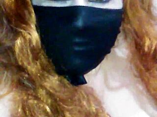 Face mask covers mouth during black dildo bondage and masturbation.