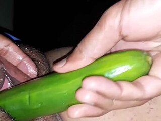 Indian wife in oiled scene with cucumber