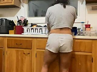 Anna Maria continues to dance and tease while washing dishes