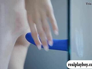 Two glamour babes fucking a blue dildo... oops, i mean playing with it