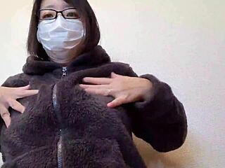 A married woman rubs her big breasts while masturbating in sensual display.