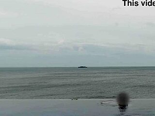 Stunning Asian college princess with ponytail shows off legs at infinity pool. Her small waist and beautiful feet shine by the water.