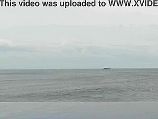 Stunning Asian college princess with ponytail shows off legs at infinity pool. Her small waist and beautiful feet shine by the water.