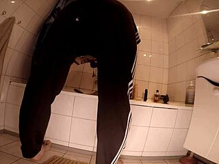 Dominant woman straps on and pounds her submissive guy hard in the steamy shower close-up.