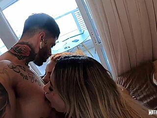 Two women with long hair and tattoos tease with tongues