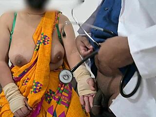 The doctor is checking the telugu aunty's boobs in the hospital with the nurse watching this indian patient scene.