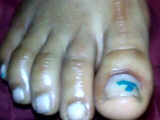 Ebony beauty delivers a teasing footjob leading to cumshot