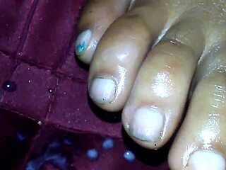 Ebony beauty delivers a teasing footjob leading to cumshot