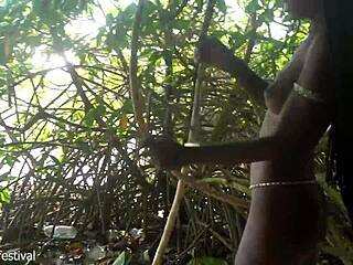 naked skinny tribe woman making a bow to go hunting