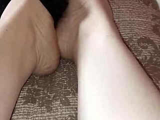 Gretala casually rubs her thong on her bare feet