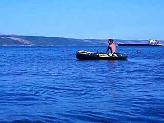 mature babe lounges in bikini on volga river boat ride