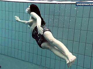 brunette flashes big tits underwater at beach pool making onlookers horny