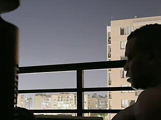Amateur couple relaxing together on balcony