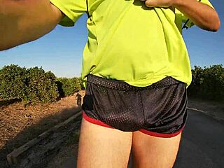 Solo male in shiny sport shorts freeballing in a public place