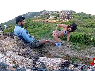 Vieuxe TV woman performs blowjob on the rocks close to the sea