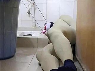 Zentai femdom commands submissive slave in toilet bondage