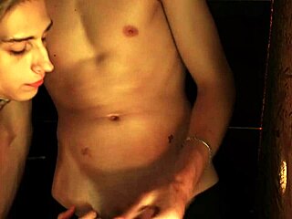 Twink performs blowjob through glory hole