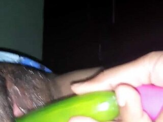 Indian wife in oiled scene with cucumber