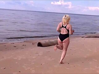 Blonde amateur in costume gets wet and wild at sea bath