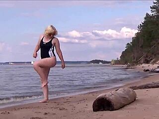 Blonde amateur in costume gets wet and wild at sea bath