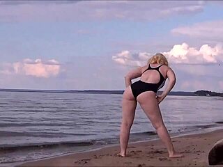 Blonde amateur in costume gets wet and wild at sea bath