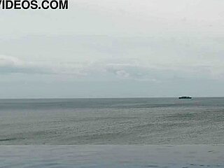 Stunning Asian college princess with ponytail shows off legs at infinity pool. Her small waist and beautiful feet shine by the water.