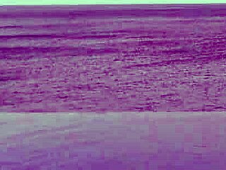 Stunning Asian college princess with ponytail shows off legs at infinity pool. Her small waist and beautiful feet shine by the water.