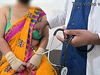 The doctor is checking the telugu aunty's boobs in the hospital with the nurse watching this indian patient scene.