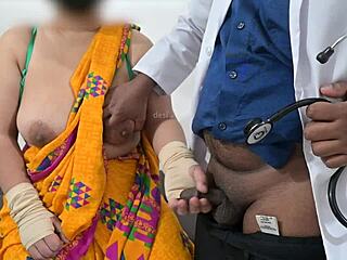 The doctor is checking the telugu aunty's boobs in the hospital with the nurse watching this indian patient scene.