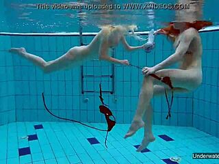 Two hot shaved lesbians kiss and touch underwater in pool