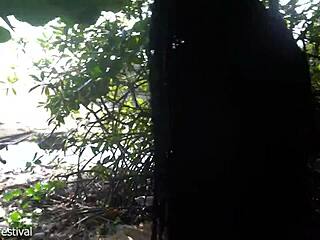 naked skinny tribe woman making a bow to go hunting