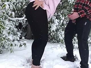 real couple enjoys outdoor fun in the snow