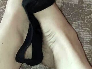 Gretala casually rubs her thong on her bare feet