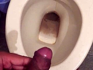 she squats low letting her monster cock drip cum while peeing nice and steady