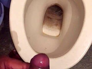 she squats low letting her monster cock drip cum while peeing nice and steady